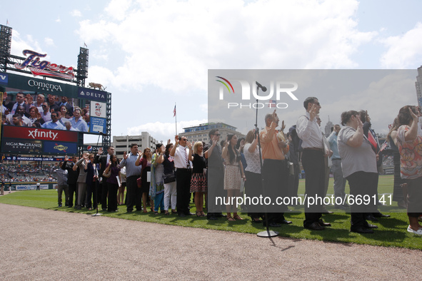 Official swearing in of 60 new American citizens administered by Judge Denise Page Hood during  pregame ceremonies of  a baseball game betwe...