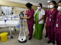 Health workers give demo of a machine where a covid patient can talk to a doctor through this machine in a temporary converted covid care un...