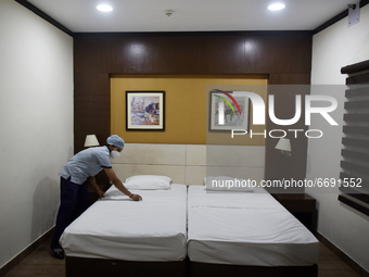A woman health worker arranges a bed of a single room of a temporary converted covid care unit in Salt Lake stadium in Kolkata, India on 7 M...