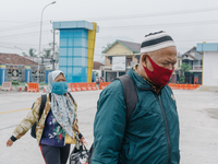 Residents bring their belongings at Bawen bus station, Semarang Regency, Indonesia on May 8, 2021. Indonesia government implement travel ban...