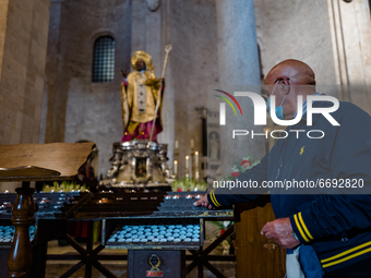 A faithful lights a candle in front of the statue of St. Nicholas in the Basilica of St. Nicholas in Bari on May 7, 2021.
The Basilica of S...
