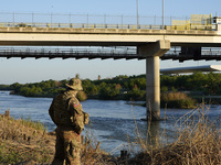 Texas National Guardsman checks the Rio Grnade near the Ciudad Miguel Alemán International Bridge for migrant corssings ion May 7 2021 in Ro...