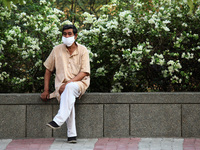 A man wearing a face mask sits along a street, amidst the spread of coronavirus cases, in New Delhi, India on May 8, 2021. India recorded ov...