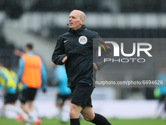 Mike Dean, the match referee, warming up before the Sky Bet Championship match between Derby County and Sheffield Wednesday at Pride Park, D...