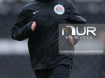Mike Dean, the match referee, warming up before the Sky Bet Championship match between Derby County and Sheffield Wednesday at Pride Park, D...