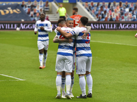 Charlie Austin of QPR celebrates after scoring his team's first goal with his team mates during the Sky Bet Championship match between Queen...