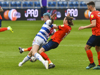 Lyndon Dykes of QPR battles for possession with Glen Rea of Luton town during the Sky Bet Championship match between Queens Park Rangers and...