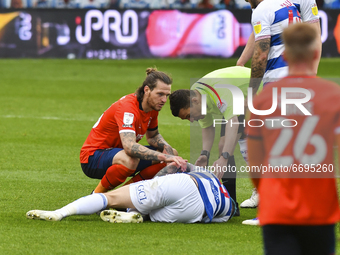 The referee Tony Harrington check up on Lyndon Dykes of QPR during the Sky Bet Championship match between Queens Park Rangers and Luton Town...
