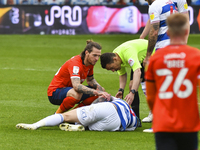 The referee Tony Harrington check up on Lyndon Dykes of QPR during the Sky Bet Championship match between Queens Park Rangers and Luton Town...