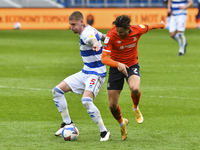 Jordy de Wijs of QPR battles for possession with Harry Cornick of Luton town during the Sky Bet Championship match between Queens Park Range...