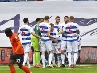 Albert Adomah of QPR celebrates after scoring his team's third goal with his team mates during the Sky Bet Championship match between Queens...
