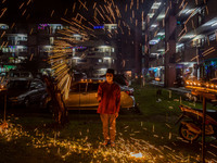 A Malaysian swings a homemade sparkler fireworks ahead of Eid al-Fitr celebrations, the religious festival that marks the end of the fasting...