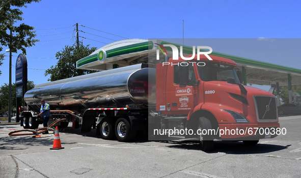 A gasoline tanker truck makes a fuel delivery at a gas station on May 9, 2021 in Orlando, Florida. According to the National Tank Truck Carr...