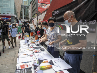 Workers standing at a booth for the June 4 Vigil in Hong Kong, Sunday, May 9, 2021. The Hong Kong Alliance in Support of Patriotic Democrati...