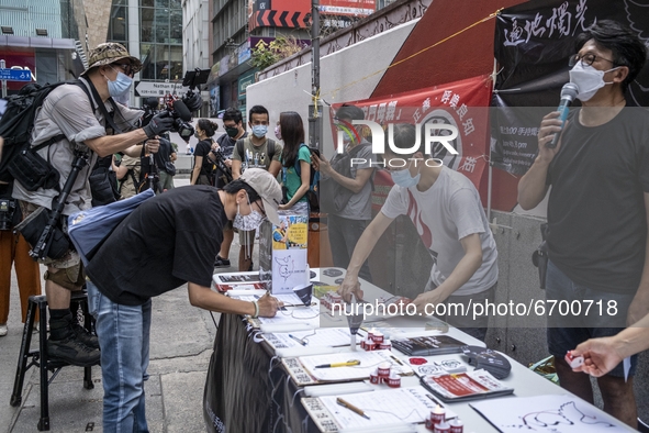 A Supporter signs a booklet at a booth for the June 4 Vigil in Hong Kong, Sunday, May 9, 2021. The Hong Kong Alliance in Support of Patrioti...