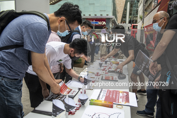A Supporter signs a booklet at a booth for the June 4 Vigil in Hong Kong, Sunday, May 9, 2021. The Hong Kong Alliance in Support of Patrioti...