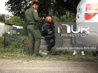 US Border Patrol agents detain illigal migrants on May 10, 2021 in Roma Texas, USA. According to unofficial estimates approximately 200,000...