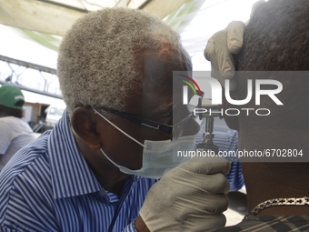 Director/Consultant Audiologist, Professor Dele Owolawi Jnr, with his Audio scope conducting a hear checkup on a driver at Branch A, Biode m...