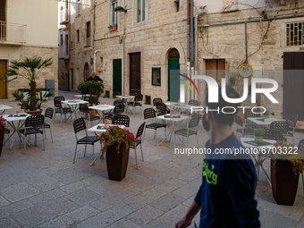 Tables and chairs of a pub prepared outdoors on the first day of reopening in the yellow zone in Molfetta on 10 May 2021.
After fifty days,...