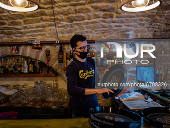 The owner of a pub cleans the trays on the first day of reopening in the yellow zone in Molfetta on 10 May 2021.
After fifty days, Puglia r...