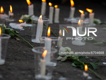 Candles and flower during members of the Shiite Hazara community show solidarity with the victims of Kabul school bombing, outside UNHCR in...
