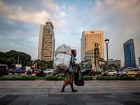 A scavenger walk at a business area in Jakarta on May 11, 2021. The Asian Development Bank (ADB) has projected the Indonesian economy to gro...