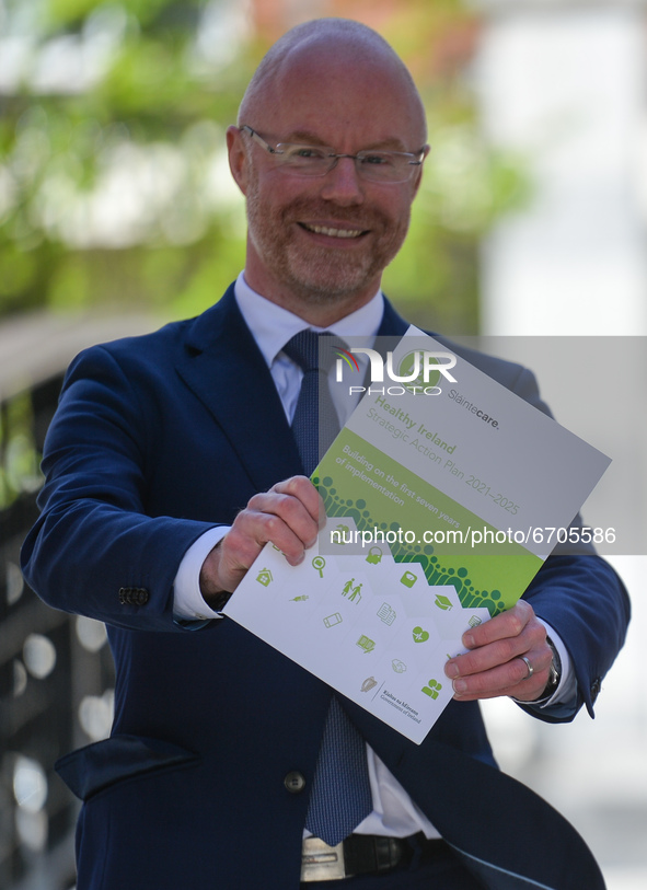 Stephen Donnelly, Ireland's Minister of Health, poses for a photo with a copy of the Healthy Ireland strategic action plan at Dublin Castle....