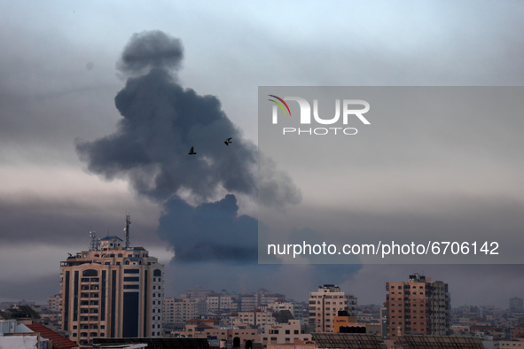 Smoke rises after an Israeli air strike in Gaza City near Barcelona Park and multiple government places, one of the biggest air strikes on t...