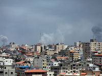 Smoke billows following Israeli airstrikes on Gaza City on May 12, 2021, amid the most intense Israeli-Palestinian hostilities in seven year...