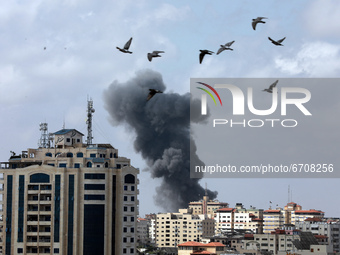  Smoke billows following an Israeli air strike on targets in Gaza City early on May 12, 2021 (