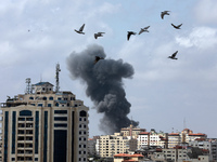  Smoke billows following an Israeli air strike on targets in Gaza City early on May 12, 2021 (