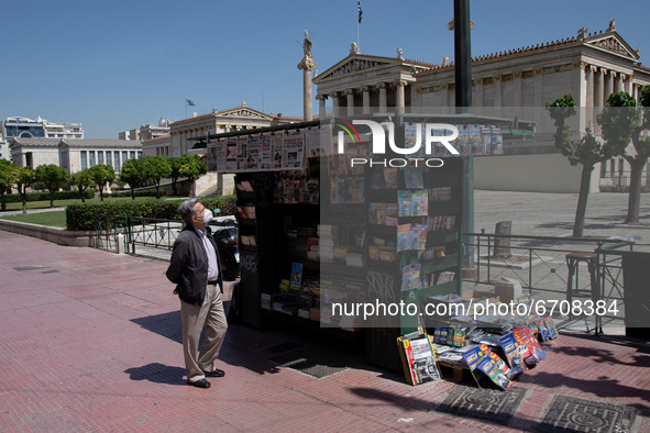 A man is looking at the newspapers at a kiosk at the center of Athens, Greece on May 12, 2021. 