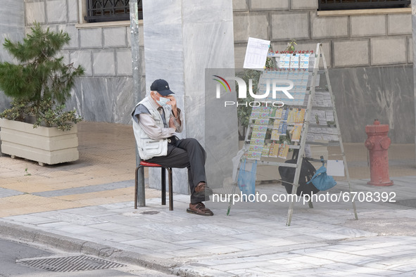 A man is selling lotteries at the center of Athens, Greece on May 12, 2021. 