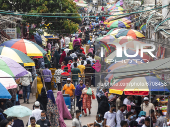 Residents gather to buy their needs at New Market ahead of Eid al Fitr in Dhaka on May 12, 2021. (