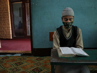Kashmiri boys read Holy Quran while observing Covid-19 SOP's in an orphanage during Ramadan in Srinagar, Indian Administered Kashmir on 12 M...