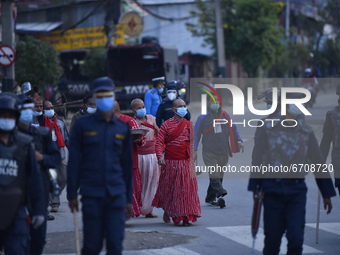 Nepalese Priest carrying idol Rato Machindranath from Machindra Bahal towards the chariot on the first day of the longest chariot festival o...