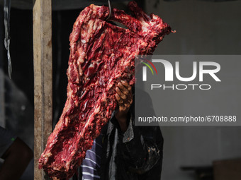 People are seen gathering a traditional market to buy meat, as a tradition before celebrating Eid al-Fitr called