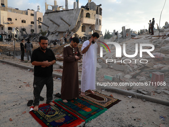 Palestinian Muslim men perform the morning Eid Al-Fitr prayer outdoors amid the destruction on the first day of the Muslim holiday which mar...