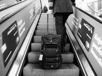 A passenger rides the escalator on their way to board their next flight at Dallas-Fort Worth International Airport on April 12, 2021. As Ame...