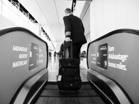 A passenger rides the escalator on their way to board their next flight at Dallas-Fort Worth International Airport on April 12, 2021. As Ame...