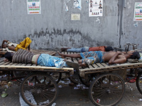 Labor of Kawran bazar area sleep in daytime in their workplace, in Dhaka, Bangladesh, on March 29, 2014. Foods are coming from long distance...