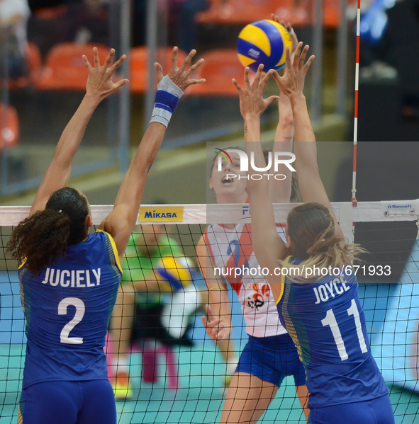 Juciely Cristina Barreto (#2) and Joyce Silva (#11) of Brazil attemp to block the spike ball from Marta Drpa of Serbia during their FIVB Wor...