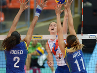 Juciely Cristina Barreto (#2) and Joyce Silva (#11) of Brazil attemp to block the spike ball from Marta Drpa of Serbia during their FIVB Wor...