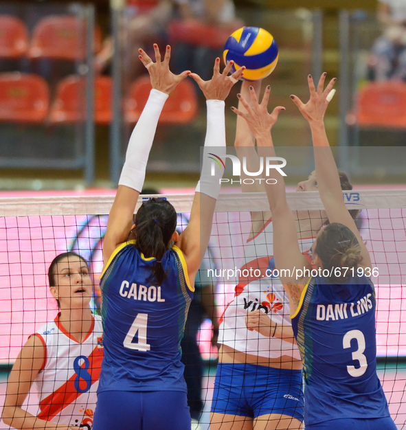 Ana Carolina Da Silva (#4) and Danielle Lins (#3) of Brazil attemp to block the spike ball from Serbia player during their FIVB World Grand...