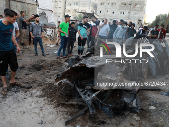 Palestinians inspect the wreckage of a car after it was hit by an Israeli missile strike in Gaza City Saturday, May 15, 2021.
 (