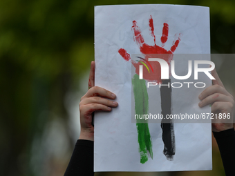 A Pro-Palestinian protester carries a sign with Palestinian colors on Northumberland Road in Dublin during 'Rally for Palestine'.
On Saturda...