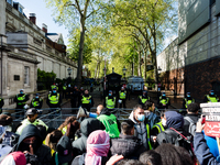Pro-Palestinian activists wave flags and banners outside Israel Embassy in London, Britain, 15 May 2021. The rally took place in protest aga...