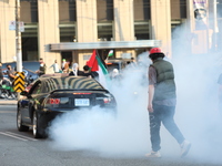 Thousand people protest in downtown Toronto, Canada on May 15, 2021 in solidarity with Palestinians. Palestinian flags and 'free Palestine'...