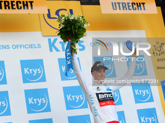 BMC Racing Team rider Rohan Dennis of Australia raises the Krys trophy, wearing the white jersey after winning Stage 1 of the Tour de France...