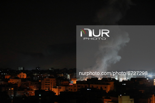Smoke billows above buildings after an Israeli airstrike on Gaza City in the Gaza Strip early on May 17, 2021. 
 